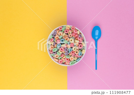 Bowl of colorful cereals and spoon top view 111908477