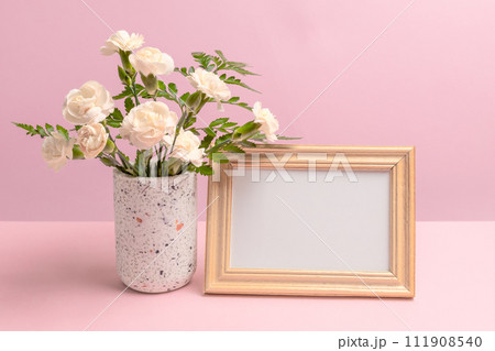 Bouquet of carnations in a vase with a photo frame. Bouquet of carnations in a vase with a photo frame. 111908540