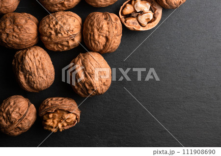 walnuts on black slate background 111908690
