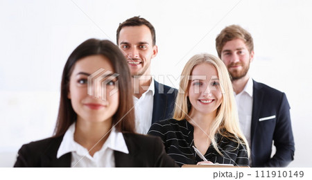 Group of smiling people stand in office 111910149