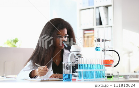 Black woman scientist student chemist in protective 111910624