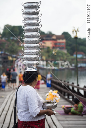 Mon woman carry bowl on head at Wooden Bridge, Sangkhlaburi Mon woman carry bowl on head at Wooden Bridge, Sangkhlaburi 111911107