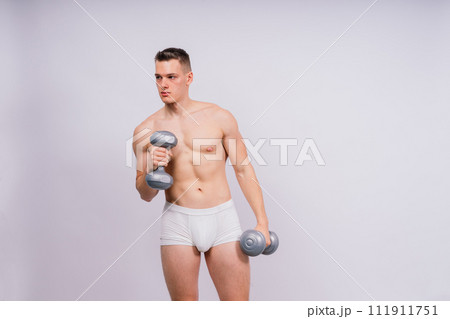 Dumbbells, fitness and man in studio for training, exercise or bodybuilding studio shot. 111911751