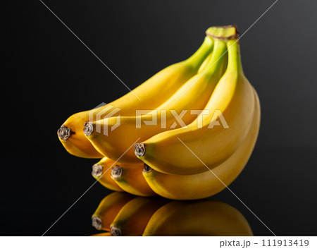Bananas on a black reflective background. Bananas on a black reflective background. 111913419