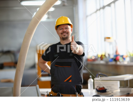 Smiling worker in yellow helmet show confirm sign 111913639