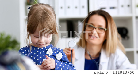 Little child with stethoscope at doctor reception 111913750
