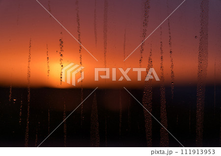 windows covered with raindrops with sunset back light 111913953