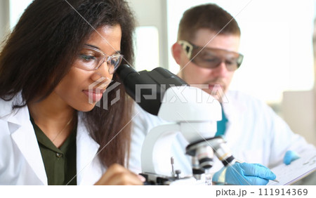 Two scientists of a student chemist are conducting Two scientists of a student chemist are conducting 111914369