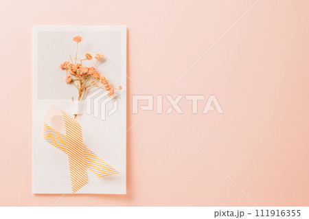 Pink awareness ribbon sign and paper card flower of World Cancer Day on pink background with copy space, concept of medical and health care support, Breast cancer awareness concept, 4 February Pink awareness ribbon sign and paper card flower of World Cancer Day on pink background with copy space, concept of medical and health care support, Breast cancer awareness concept, 4 February 111916355