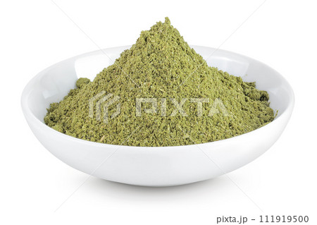 ground Laurel leaves in ceramic bowl isolated on white background. Green bay leaf 111919500