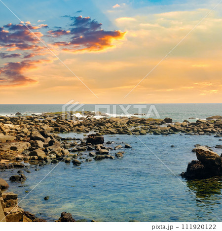 Picturesque tropical beach with boulders and beautiful sunset. 111920122