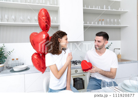 Man makes a gift at the Valentines day celebration 111920877