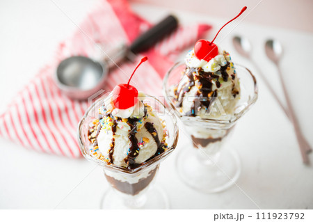 ice cream sundae with cherries and nuts 111923792