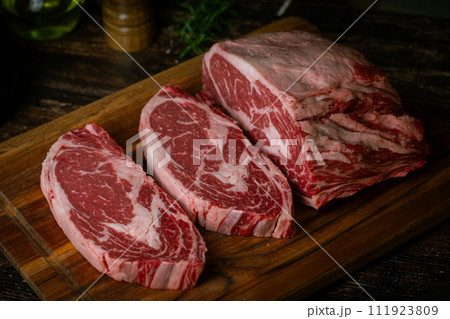 chunk of ribeye steak on wooden board chunk of ribeye steak on wooden board 111923809
