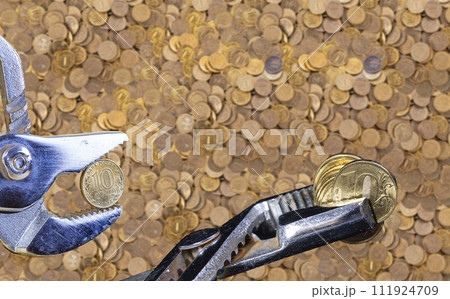 Allegory of the global financial crisis - Iron 10 rubles coin (written ten rubles, the Bank of Russia) in the grip of economic crisis. Finance and business concept Allegory of the global financial crisis - Iron 10 rubles coin (written ten rubles, the Bank of Russia) in the grip of economic crisis. Finance and business concept 111924709