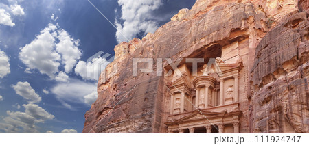 Al Khazneh or The Treasury (against the background of a beautiful sky with clouds). Petra, Jordan-- it is a symbol of Jordan, as well as Jordan's most-visited tourist attraction Al Khazneh or The Treasury (against the background of a beautiful sky with clouds). Petra, Jordan-- it is a symbol of Jordan, as well as Jordan's most-visited tourist attraction 111924747