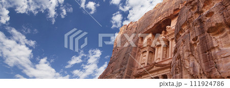 Al Khazneh or The Treasury (against the background of a beautiful sky with clouds). Petra, Jordan-- it is a symbol of Jordan, as well as Jordan's most-visited tourist attraction 111924786