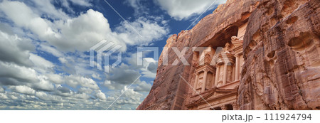 Al Khazneh or The Treasury (against the background of a beautiful sky with clouds). Petra, Jordan-- it is a symbol of Jordan, as well as Jordan's most-visited tourist attraction Al Khazneh or The Treasury (against the background of a beautiful sky with clouds). Petra, Jordan-- it is a symbol of Jordan, as well as Jordan's most-visited tourist attraction 111924794