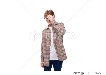 young smart red-haired guy in a plaid shirt over a t-shirt young smart red-haired guy in a plaid shirt over a t-shirt 111926270