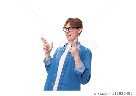 young cheerful red-haired guy dressed in a blue shirt over a t-shirt 111926495