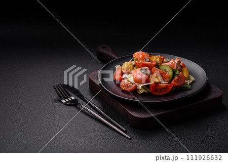 Delicious juicy salad with salmon, tomatoes, cucumber, herbs, pumpkin seeds, salt and spices 111926632