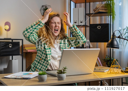 Displeased sad office woman using laptop working loses bad news computer virus fail loss game Displeased sad office woman using laptop working loses bad news computer virus fail loss game 111927017
