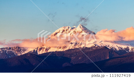 Snow Covered Canadian Rocky Mountain peaks. Sunny Cloudy Sunset 111927419