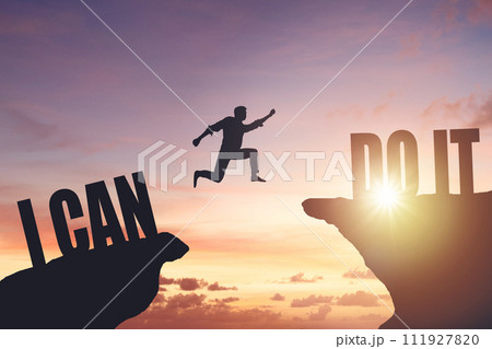 Silhouette of a man jumping from cliff to cliff, business and success concept 111927820
