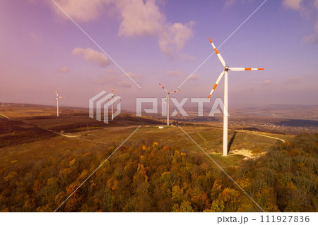 Wind generators in a green field. Alternative energy source. 111927836