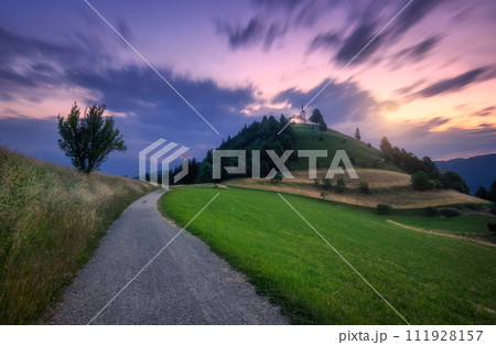 Rural road and chapel on the mountain peak at twilight 111928157