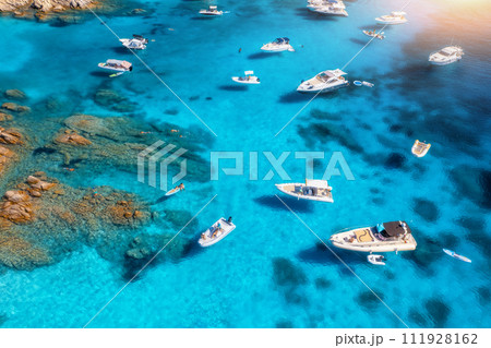 Aerial view of luxury yachts and boats on blue sea on sunny day Aerial view of luxury yachts and boats on blue sea on sunny day 111928162