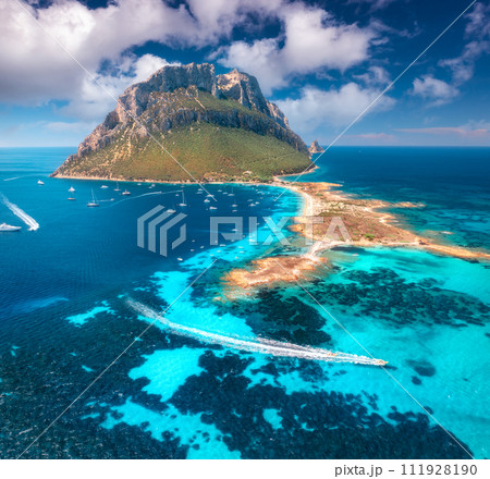 Aerial view of luxury yachts and floating speed boats on blue sea 111928190