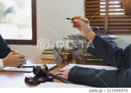 Law and justice concept, Senior lawyer explaining and provide legal advice to young female lawyer Law and justice concept, Senior lawyer explaining and provide legal advice to young female lawyer 111936978