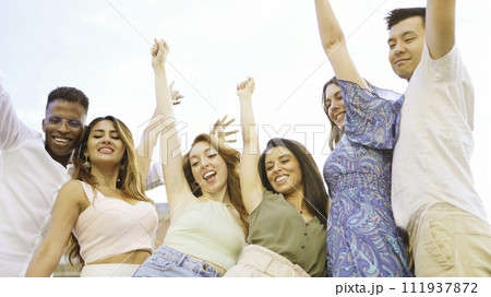 Happy group of friends raising the arms while smiling 111937872