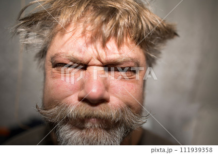 A man with facial hair is grinning widely for a portrait photography event 111939358