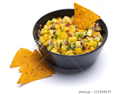 Freshly made mango salsa in a black ceramic bowl Freshly made mango salsa in a black ceramic bowl 111939575