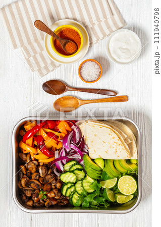vegan fajitas with mushrooms, veggies on sheet pan 111940798