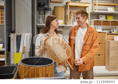 Cheerful man and woman couple deciding to buy craft furniture for home Cheerful man and woman couple deciding to buy craft furniture for home 111946041