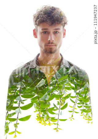 A double exposure male portrait merged with green shoots at the bottom 111947237