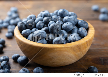 Fresh blueberry in wooden bowl. Concept of healthy and dieting eating. 111947410