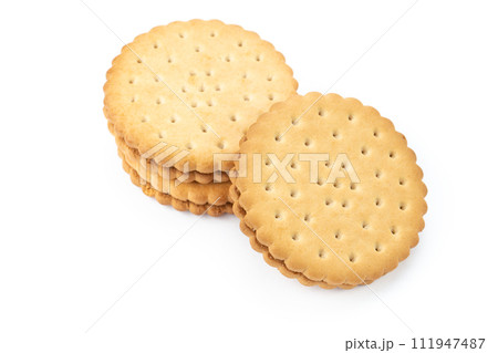 Two round sandwich biscuits isolated on a white background. 111947487