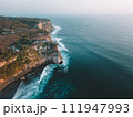 Aerial view of Pura Luhur Uluwatu Temple and the Cliffs at sunset 111947993
