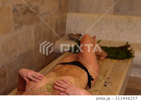 Girl in bikini relaxes after massage in hammam 111948257