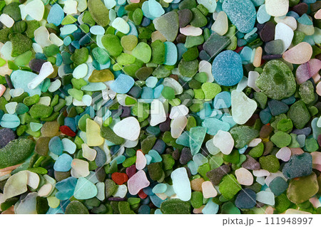 Multi-colored background from sea-polished glass shards of bottles. Glass beach 111948997
