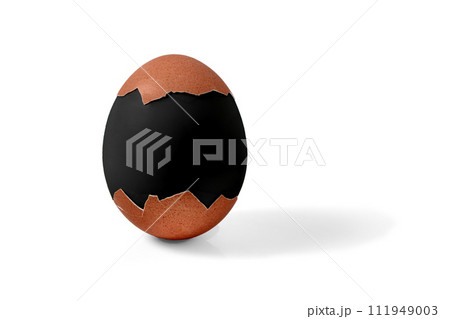 Half shelled boiled Easter chicken egg painted in black mourning color isolated on a white background 111949003