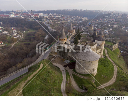 Aerial Drone view of the ancient fortress at winter in dawn. Castle in the city of Kamenetz-Podolsky, Ukraine. Aerial Drone view of the ancient fortress at winter in dawn. Castle in the city of Kamenetz-Podolsky, Ukraine. 111950633