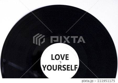 Love yourself symbol. Concept words Love yourself on beautiful black vinyl disk. Beautiful white table white background. Psychology love yourself concept. Copy space. Love yourself symbol. Concept words Love yourself on beautiful black vinyl disk. Beautiful white table white background. Psychology love yourself concept. Copy space. 111951175