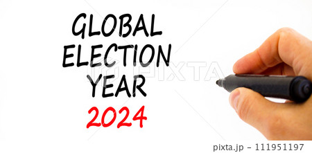 Global election year 2024 symbol. Concept words Global election year 2024 on beautiful white paper. Beautiful white background. Voter hand. Business Global election year 2024 concept. Copy space 111951197