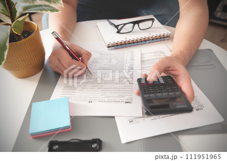 Tax time, tax concept with man filling tax form 111951965