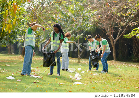Group of students picking garbage in local park Group of students picking garbage in local park 111954884